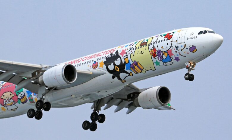 Airplane adorned with vibrant Sanrio characters, soaring in clear skies.