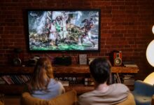 A couple enjoys playing video games on a cozy evening at home.