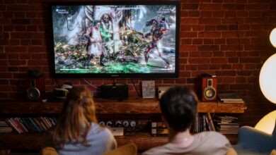 A couple enjoys playing video games on a cozy evening at home.