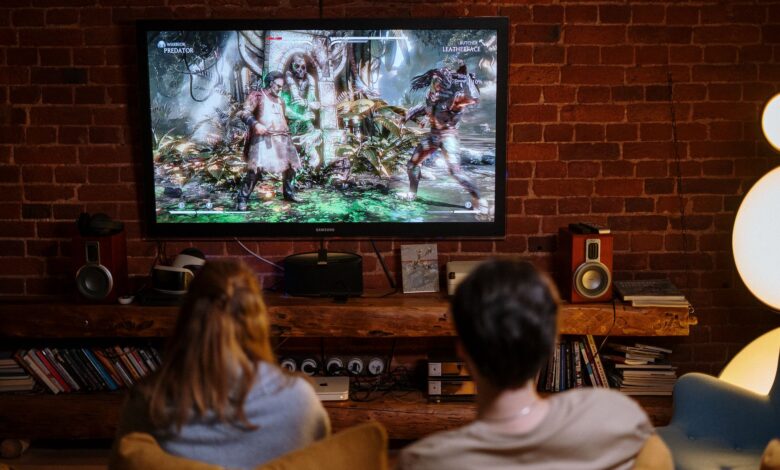 A couple enjoys playing video games on a cozy evening at home.