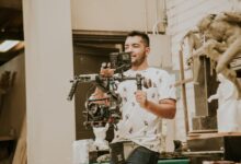 Videographer working with a professional stabilizing rig indoors, capturing behind-the-scenes moments.