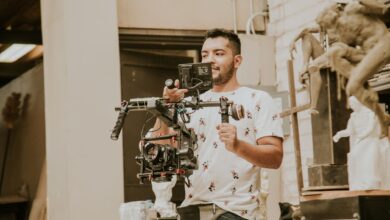 Videographer working with a professional stabilizing rig indoors, capturing behind-the-scenes moments.