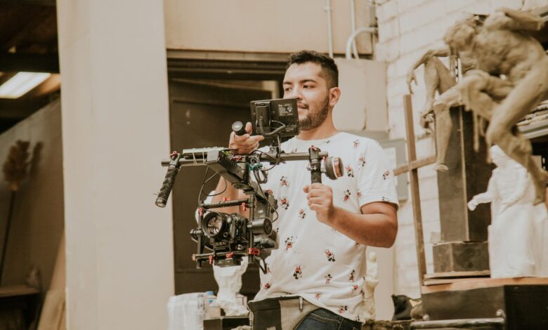 Videographer working with a professional stabilizing rig indoors, capturing behind-the-scenes moments.