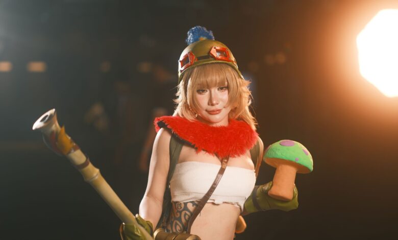 Female cosplayer in vibrant costume holding a toy prop, showcasing charismatic character portrayal.