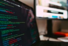 A detailed view of programming code displayed on a laptop screen, depicting a tech workspace.