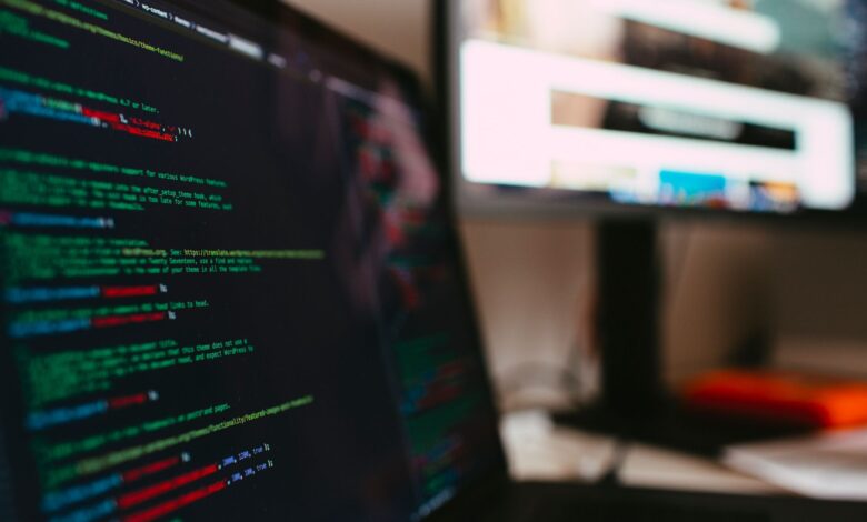 A detailed view of programming code displayed on a laptop screen, depicting a tech workspace.