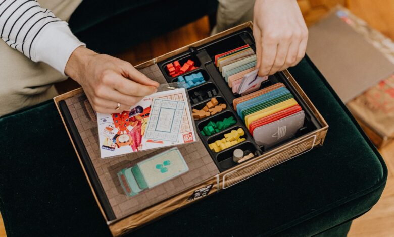 Close-up of a board game setup being organized for a fun leisure activity.