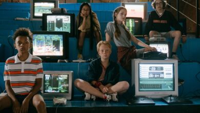 Group of teenagers interacting with old school video game consoles, evoking 80s nostalgia.