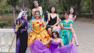 A cheerful group of women in fantasy costumes posing outdoors, exuding vibrant colors and playful energy.