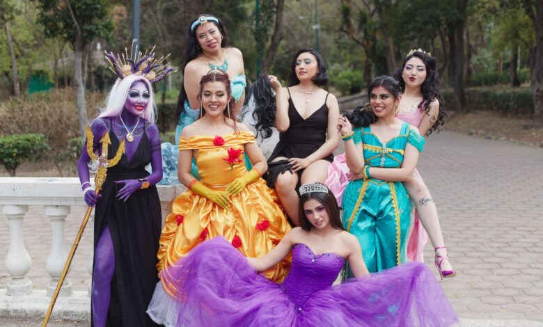 A cheerful group of women in fantasy costumes posing outdoors, exuding vibrant colors and playful energy.