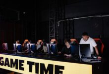 Esports team engaged in competitive gaming session indoors, showcasing teamwork and concentration.