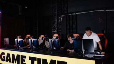 Esports team engaged in competitive gaming session indoors, showcasing teamwork and concentration.