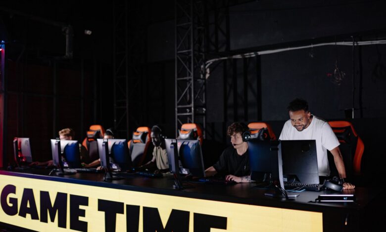 Esports team engaged in competitive gaming session indoors, showcasing teamwork and concentration.