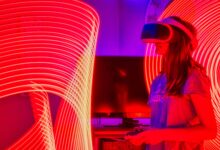 Woman immersed in virtual reality while surrounded by dynamic neon lights indoors.