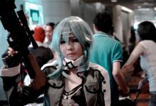 Vibrant cosplay participant posing indoors at a bustling convention scene.