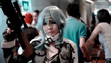 Vibrant cosplay participant posing indoors at a bustling convention scene.