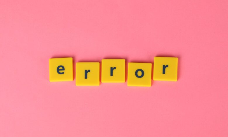 Yellow block letters spelling 'error' on a vibrant pink background, capturing a playful message.