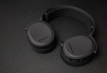 Close-up of SteelSeries headphones on a black surface. Minimalist and sleek.