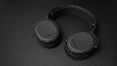 Close-up of SteelSeries headphones on a black surface. Minimalist and sleek.