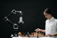 A woman plays chess against a robotic arm, showcasing AI innovation in a modern setting.
