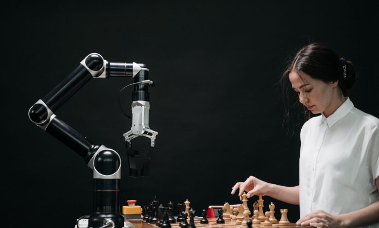 A woman plays chess against a robotic arm, showcasing AI innovation in a modern setting.