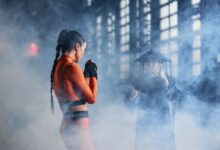 Two cosplayers in martial arts poses creating an intense and dramatic scene.
