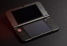 Detailed photo of a Nintendo 3DS console with dual screens and buttons, perfect for gaming enthusiasts.