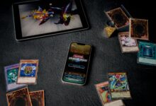 Yu-Gi-Oh cards displayed with tablet and phone, featuring Duel Links game.