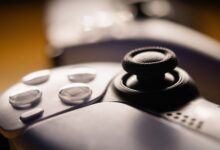 Detailed close-up of a video game controller with focus on buttons and joystick.