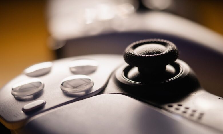 Detailed close-up of a video game controller with focus on buttons and joystick.