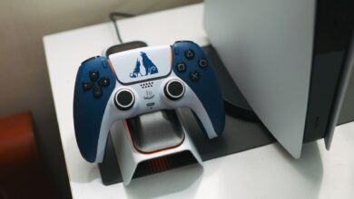 Close-up of a DualSense controller charging on a dock, perfect for gaming setups.