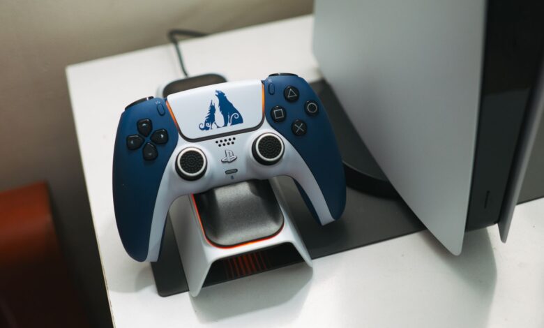 Close-up of a DualSense controller charging on a dock, perfect for gaming setups.