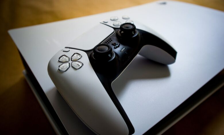 Detailed shot of a PlayStation 5 controller resting on the console, highlighting modern gaming design.