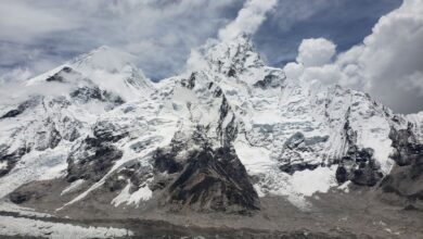 Stunning capture of snow-capped peaks in the Himalayas under a cloudy sky, Khumjung, Nepal.
