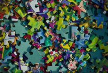Vivid close-up of colorful jigsaw puzzle pieces scattered randomly.
