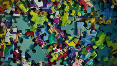 Vivid close-up of colorful jigsaw puzzle pieces scattered randomly.
