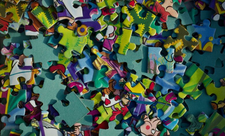 Vivid close-up of colorful jigsaw puzzle pieces scattered randomly.