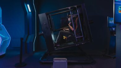 A person using a VR simulator in a high-tech gaming environment.