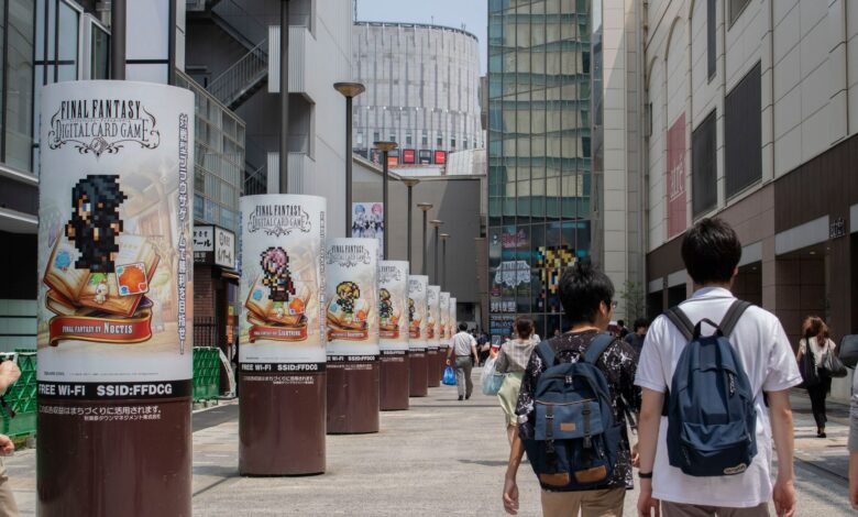 Bustling urban street in Chiyoda City, Tokyo with pedestrians and Final Fantasy ads.