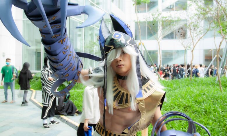 Young adult in cosplay costume at outdoor event with futuristic armor.