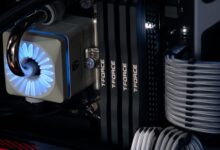 Detailed close-up of a computer cooling system featuring T-FORCE components and blue lighting.