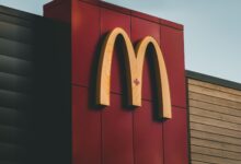 Close-up of McDonald's logo featuring a maple leaf on a building in Surrey, BC, Canada.