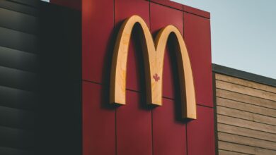 Close-up of McDonald's logo featuring a maple leaf on a building in Surrey, BC, Canada.