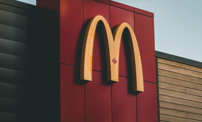 Close-up of McDonald's logo featuring a maple leaf on a building in Surrey, BC, Canada.