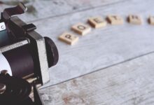 Close-up of a vintage typewriter with the word 'Poetry' spelled out on Scrabble tiles.