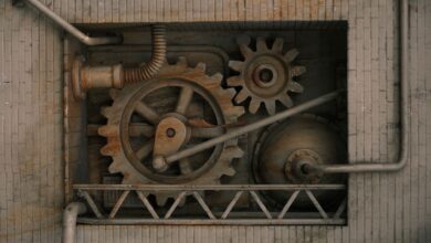Detailed view of mechanical gears and pipes built into a brick wall, showcasing industrial design.