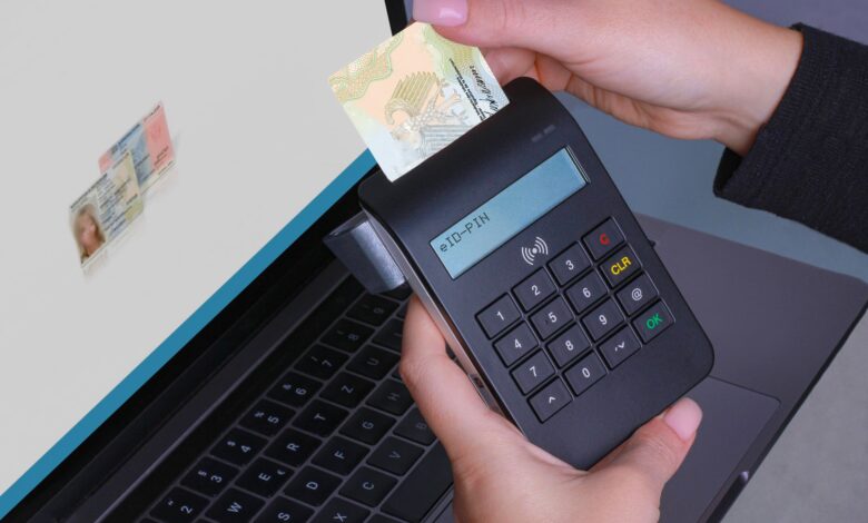 Person using contactless device for ID payment verification on a laptop.