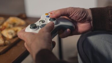 A senior adult holding a game controller, enjoying a leisurely moment indoors.