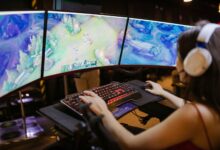 A young woman intently gaming on a multi-screen setup, showcasing vibrant gaming visuals.