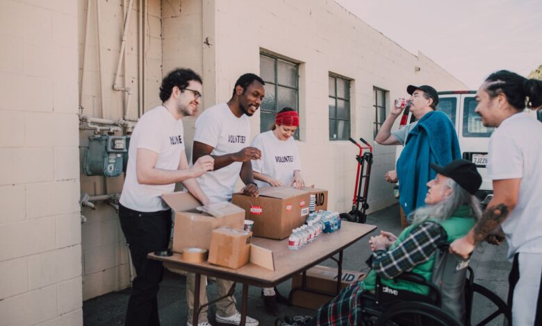 A group of diverse volunteers engaging in a community service activity outdoors, providing aid and support.